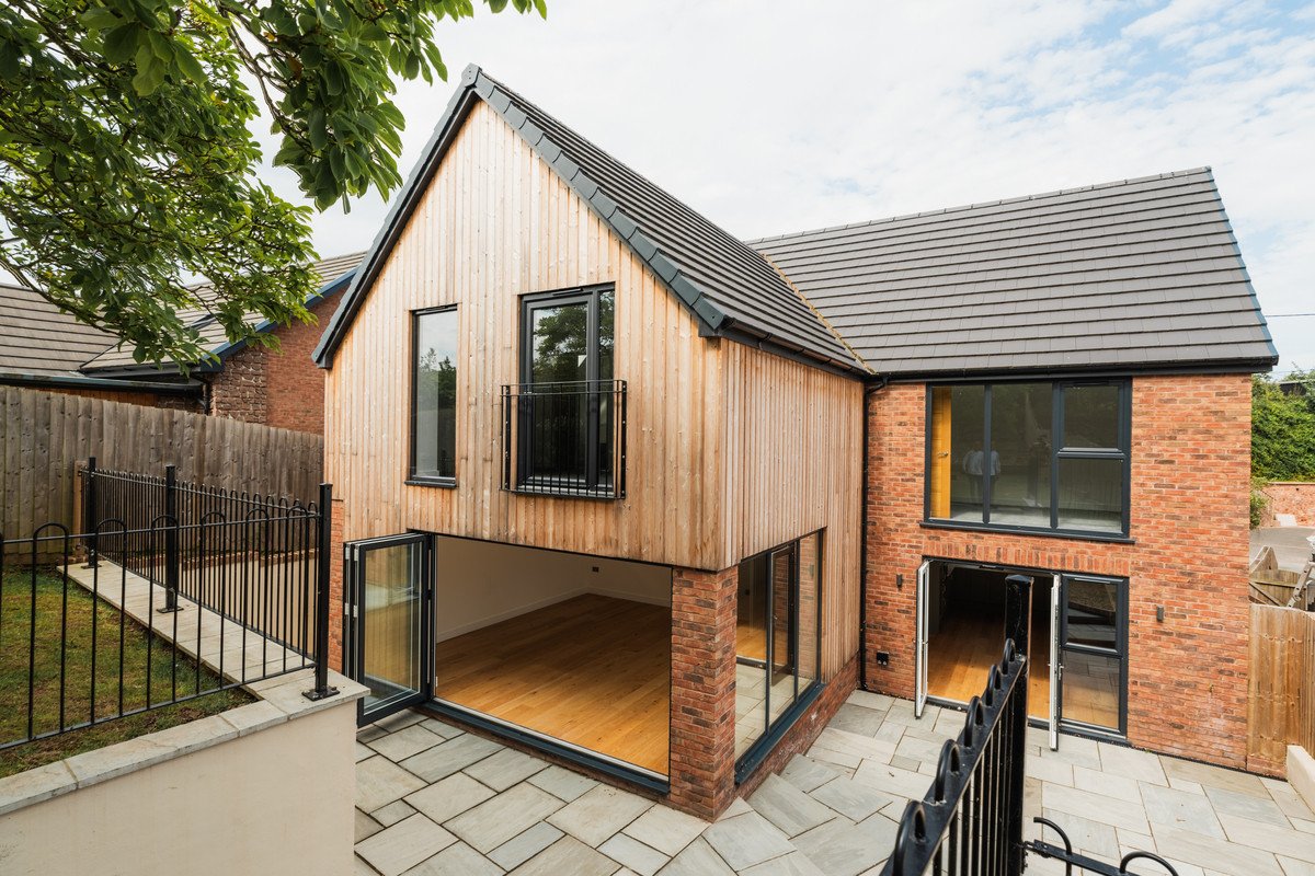 The modern brick and timber-clad Brook Street home in North Newton, with large doors opening to its terrace