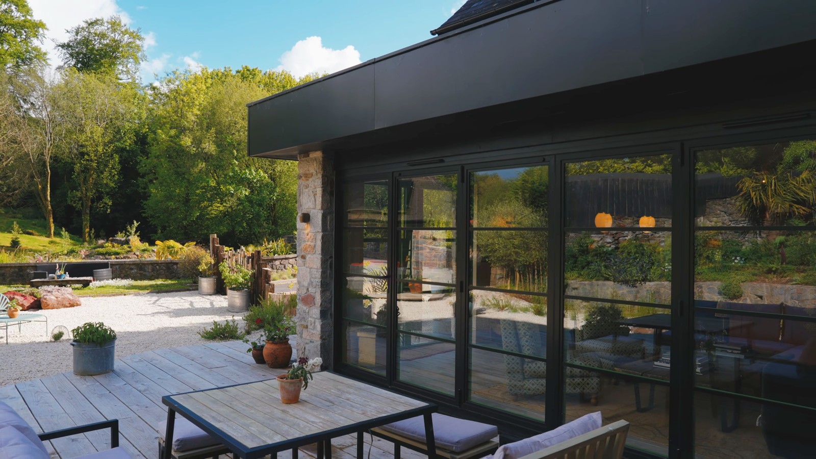 Glazed doors opening towards a landscaped terrace
